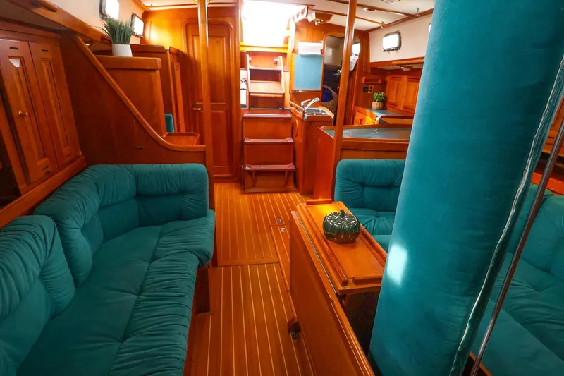 Slide: The Image of Luxurious interior of 2001 Tartan 4100 yacht with teal upholstery and wooden finishes. - 45