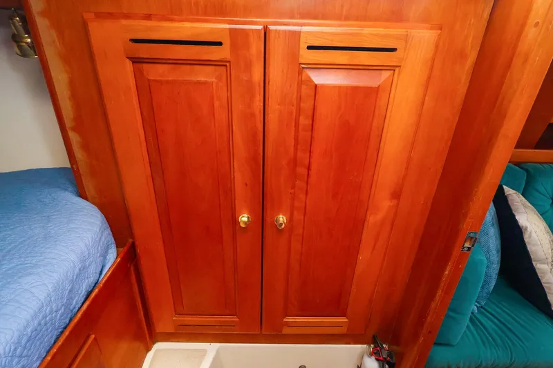 Slide: The Image of Wooden cabinet doors inside a 2001 Tartan 4100 yacht cabin. - 50