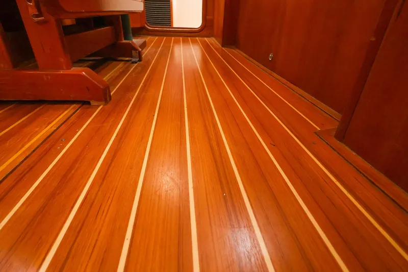 Slide: The Image of Polished wooden floor inside a 2001 Tartan 4100 yacht cabin. - 52