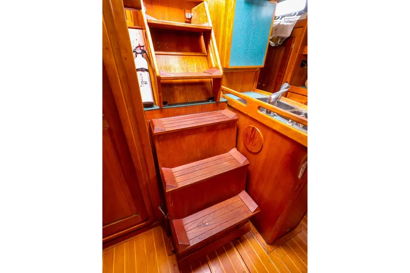 Slide: The Image of Wooden interior stairs and kitchen area in a 2001 Tartan 4100 yacht. - 53