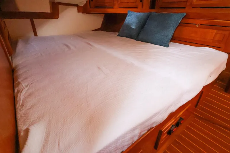 Slide: The Image of Cozy cabin bed with white linens and blue pillows in 2001 Tartan 4100 sailboat. - 55
