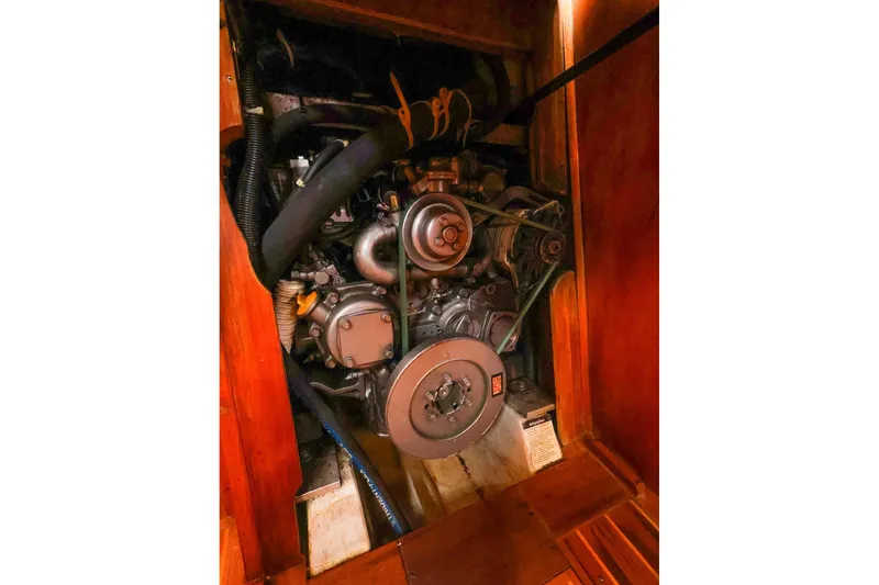 Slide: The Image of Engine compartment of a 2001 Tartan 4100 sailboat, showcasing mechanical components. - 59