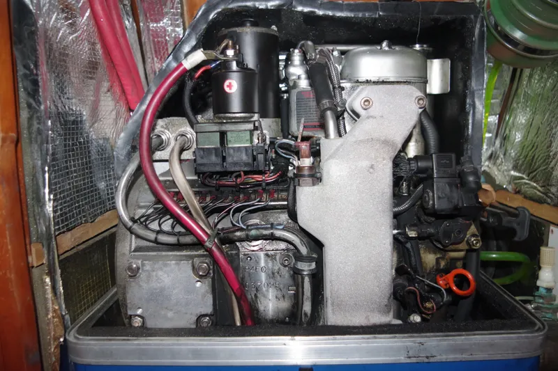 Slide: The Image of Engine compartment of a 2001 Tartan 4100 sailboat, showcasing mechanical components and wiring. - 60