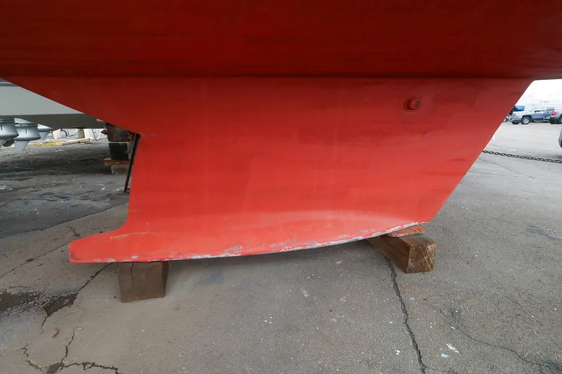 Slide: The Image of Red keel of a 2001 Tartan 4100 sailboat on wooden blocks. - 63