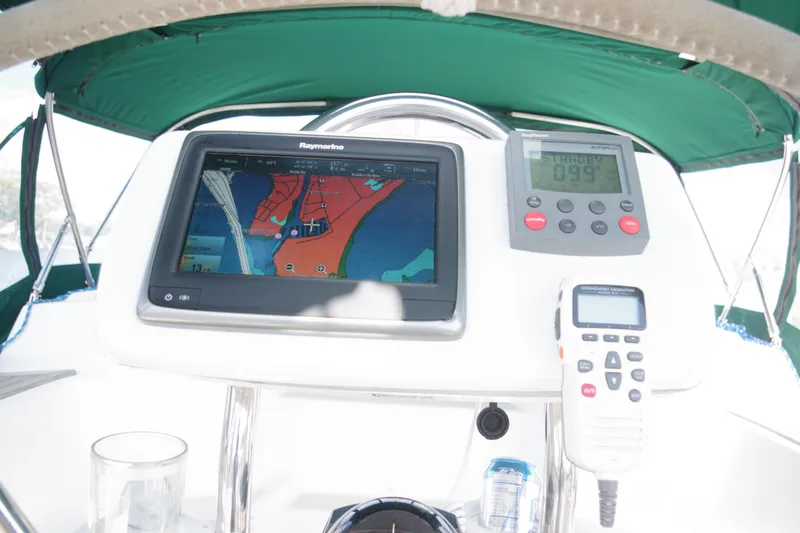 Slide: The Image of Cockpit of 2001 Tartan 4100 sailboat with navigation equipment and green canopy. - 9