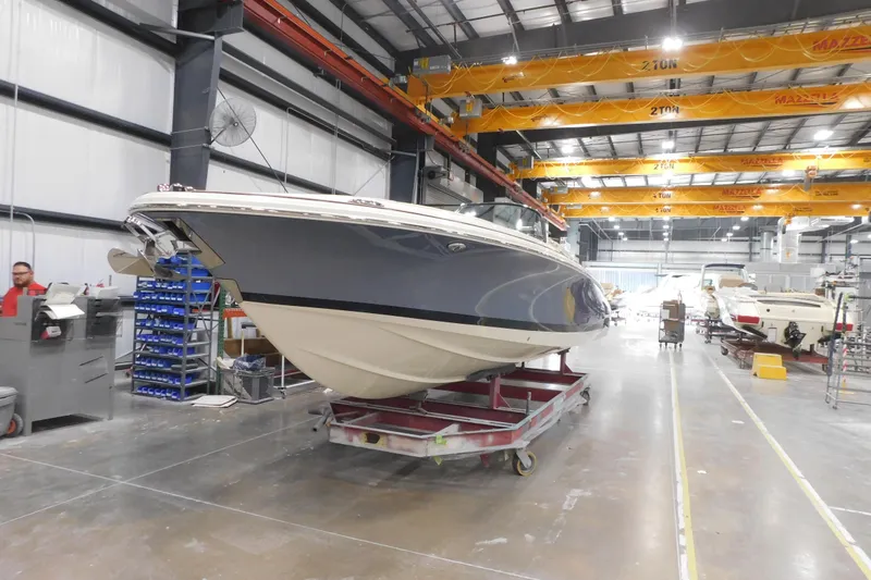 Slide: The Image of 2026 Chris-Craft Launch 27 boat in a manufacturing facility, showcasing sleek design and craftsmanship. - 4