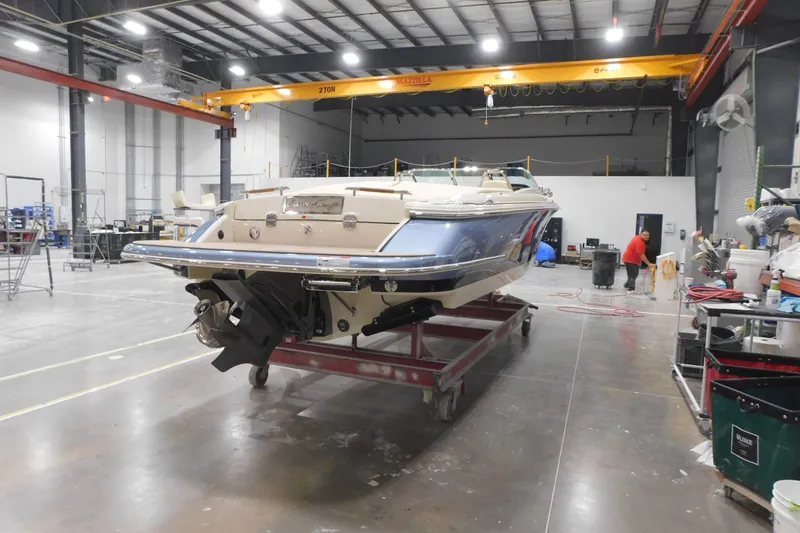Slide: The Image of 2026 Chris-Craft Launch 27 boat in a workshop setting, under bright lighting. - 5