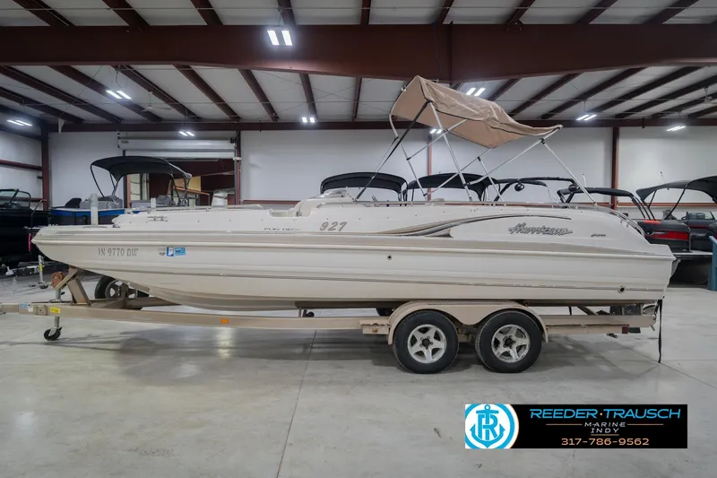 Slide: The Image of 2002 Hurricane SunDeck Sport 232 OB boat on trailer in indoor showroom. - 11