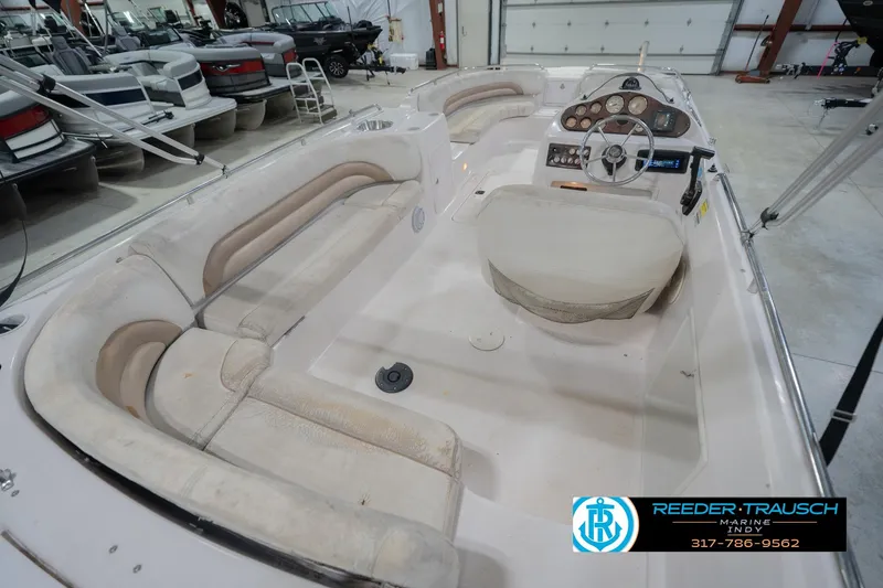 Slide: The Image of 2002 Hurricane SunDeck Sport 232 OB boat interior with seating and control panel. - 14