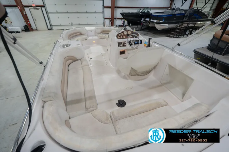 Slide: The Image of 2002 Hurricane SunDeck Sport 232 OB boat interior with spacious seating in a showroom. - 15