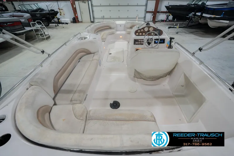 Slide: The Image of 2002 Hurricane SunDeck Sport 232 OB interior with spacious seating and control panel. - 16