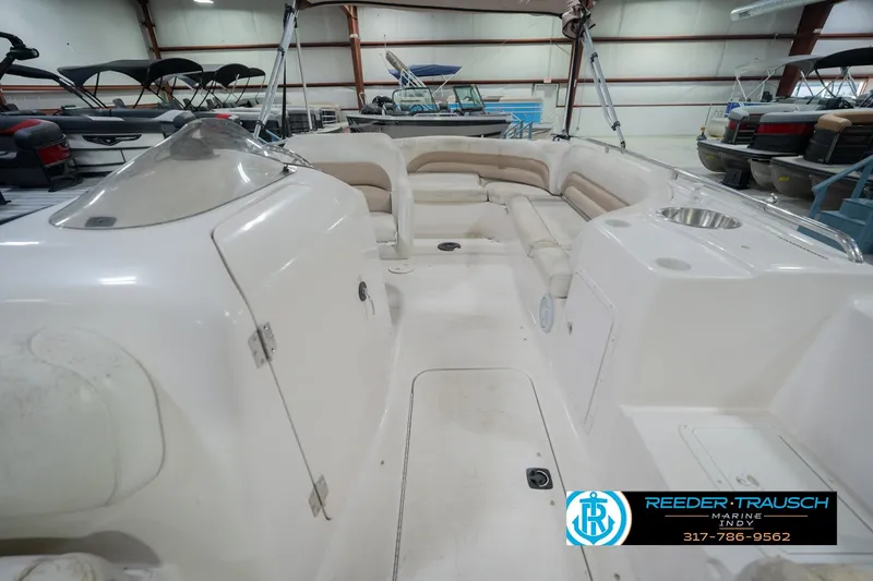 Slide: The Image of 2002 Hurricane SunDeck Sport 232 OB boat interior with seating and storage in a showroom. - 20