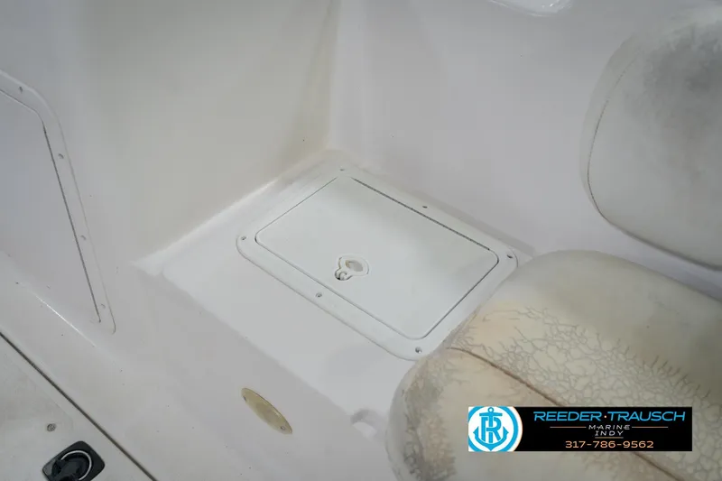 Slide: The Image of 2002 Hurricane SunDeck Sport 232 OB boat interior with storage compartment and seating. - 24