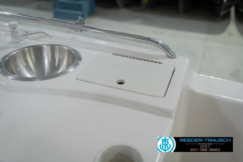 Slide: The Image of 2002 Hurricane SunDeck Sport 232 OB boat sink and cutting board detail. - 28