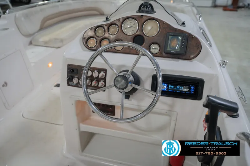 Slide: The Image of 2002 Hurricane SunDeck Sport 232 OB boat dashboard with steering wheel and control panel. - 30