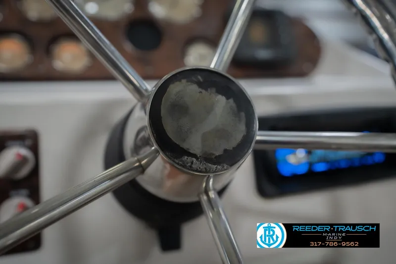 Slide: The Image of Close-up of 2002 Hurricane SunDeck Sport 232 OB steering wheel with control panel. - 32