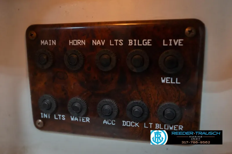 Slide: The Image of Control panel of a 2002 Hurricane SunDeck Sport 232 OB boat with labeled switches. - 33