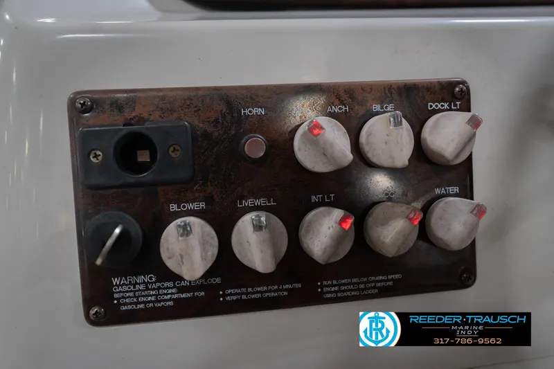 Slide: The Image of Control panel of a 2002 Hurricane SunDeck Sport 232 OB boat with various switches. - 34