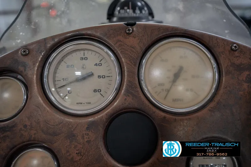 Slide: The Image of Dashboard of a 2002 Hurricane SunDeck Sport 232 OB boat with gauges and logo. - 36