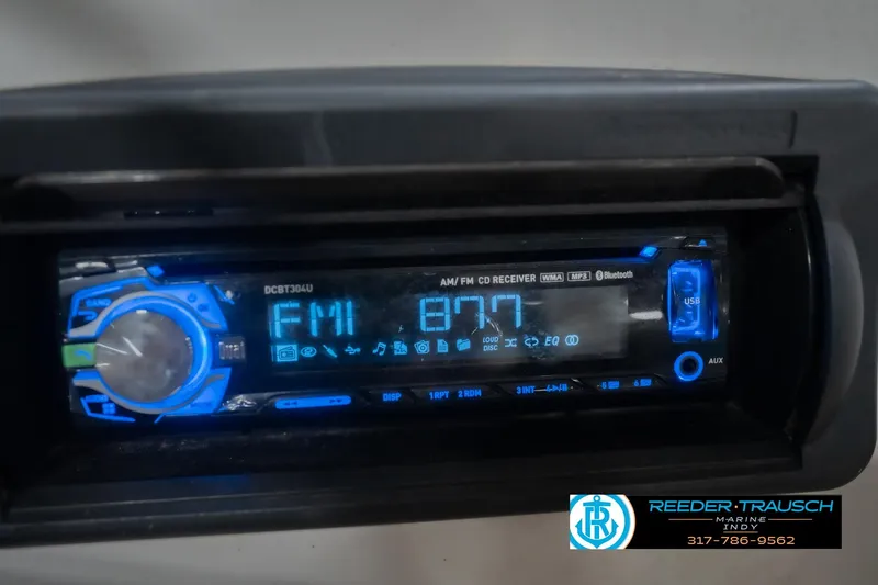 Slide: The Image of Boat stereo system in a 2002 Hurricane SunDeck Sport 232 OB, displaying FM 87.7. - 38