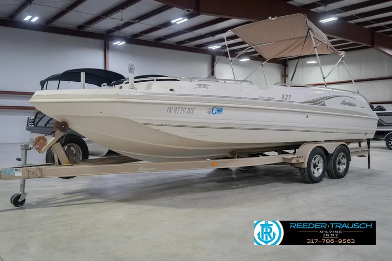 Slide: The Image of 2002 Hurricane SunDeck Sport 232 OB boat on trailer in indoor storage facility. - 4