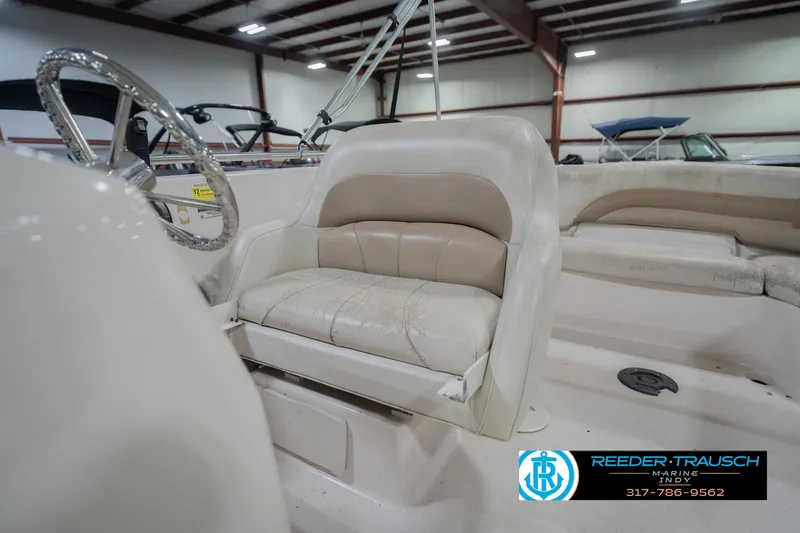 Slide: The Image of 2002 Hurricane SunDeck Sport 232 OB boat interior with steering wheel and seating. - 40