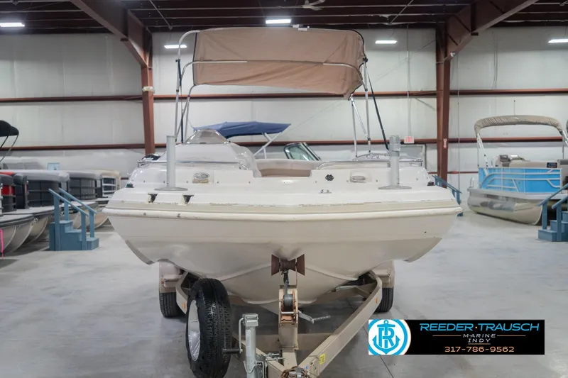 Slide: The Image of 2002 Hurricane SunDeck Sport 232 OB boat in indoor showroom with canopy. - 5
