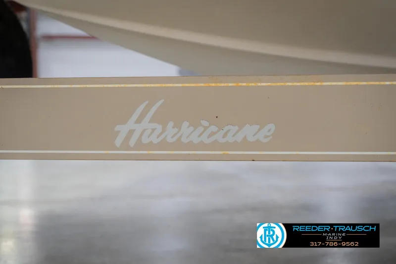 Slide: The Image of 2002 Hurricane SunDeck Sport 232 OB boat trailer with logo and contact information. - 55