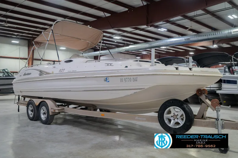 Slide: The Image of 2002 Hurricane SunDeck Sport 232 OB boat on trailer in indoor storage facility. - 6