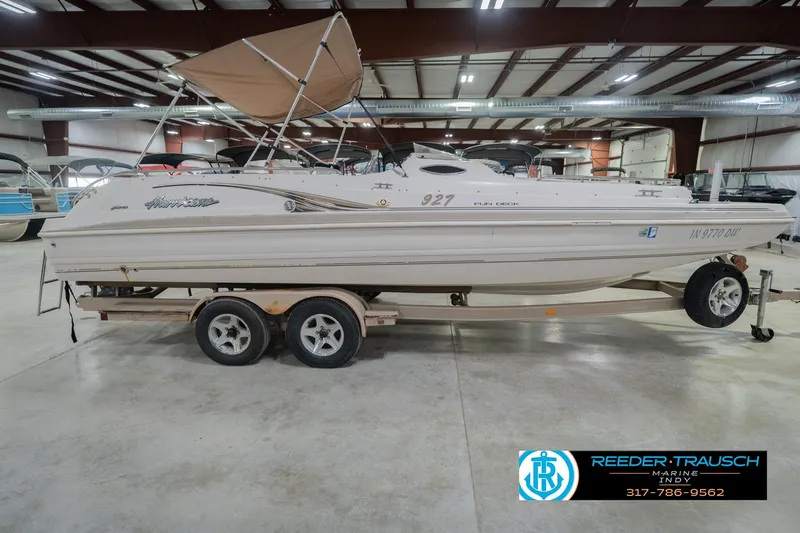 Slide: The Image of 2002 Hurricane SunDeck Sport 232 OB boat on trailer in indoor showroom. - 7