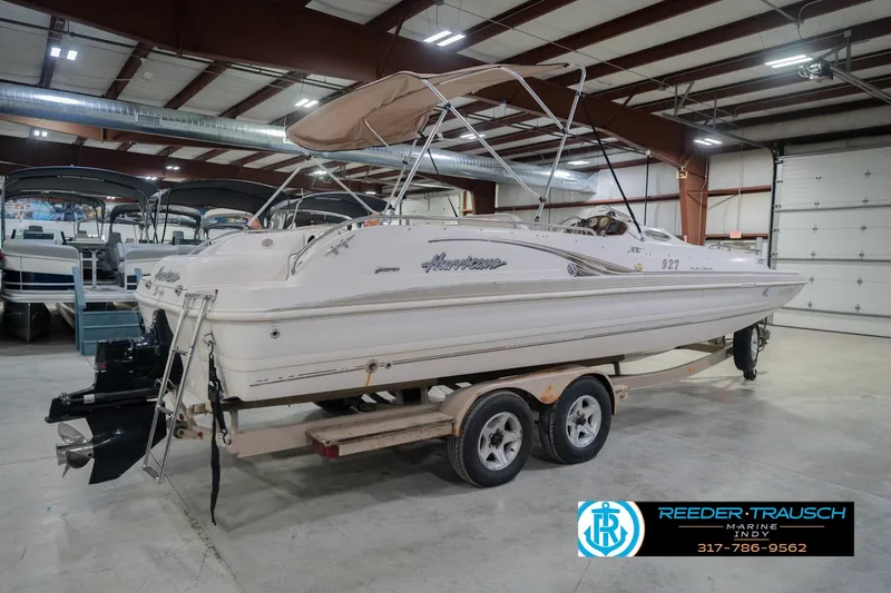 Slide: The Image of 2002 Hurricane SunDeck Sport 232 OB boat on trailer in indoor showroom. - 8