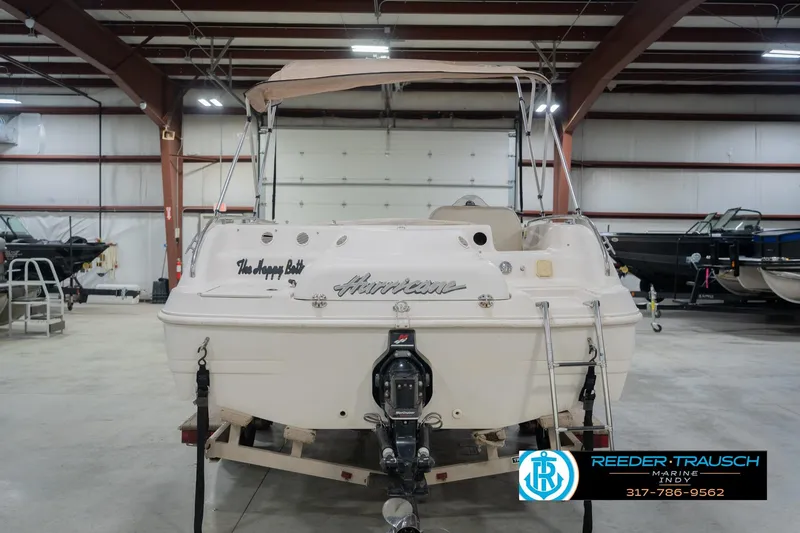 Slide: The Image of 2002 Hurricane SunDeck Sport 232 OB boat in indoor storage facility. - 9