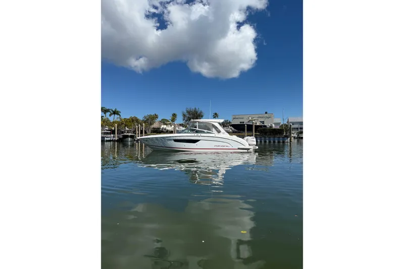 The Image of 2018 Regal 33 OBX boat on calm water under a blue sky. - 0