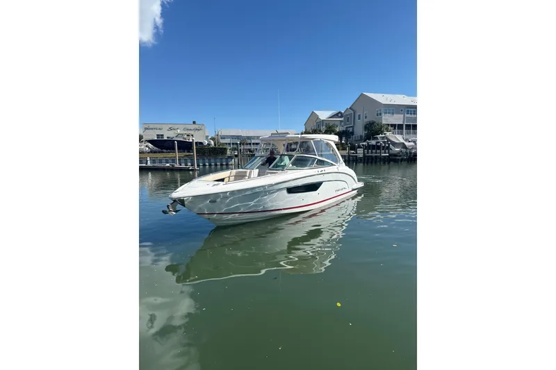 Slide: The Image of 2018 Regal 33 OBX boat docked in a marina under clear blue skies. - 1