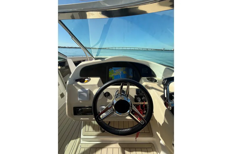 Slide: The Image of 2018 Regal 33 OBX boat helm with steering wheel and navigation screen. - 12