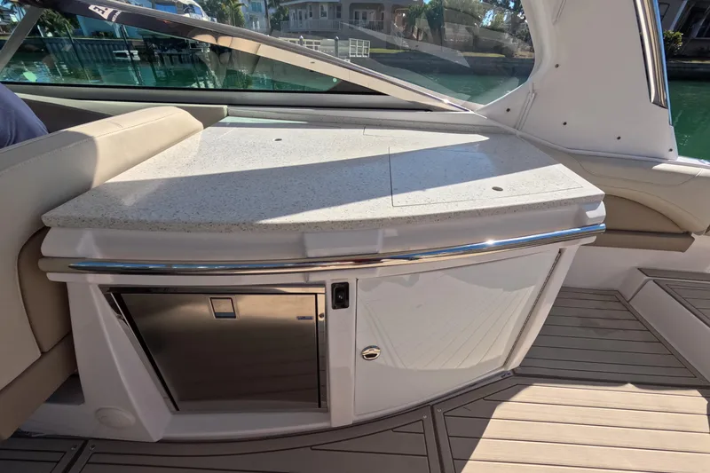 Slide: The Image of 2018 Regal 33 OBX boat interior with sleek countertop and built-in storage. - 17
