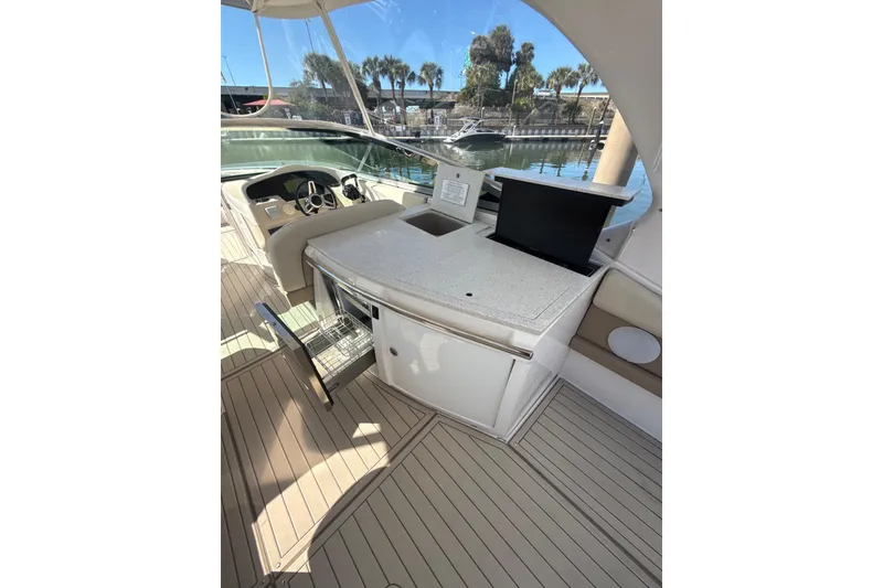 Slide: The Image of 2018 Regal 33 OBX boat interior with helm, seating, and open storage compartment. - 18
