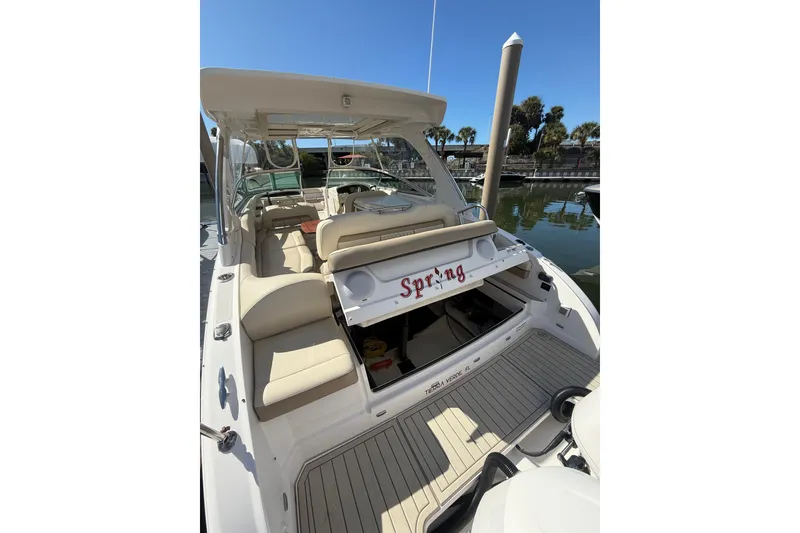 Slide: The Image of 2018 Regal 33 OBX boat with beige seating, docked at marina. - 21