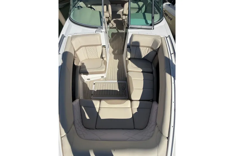 Slide: The Image of 2018 Regal 33 OBX boat interior with beige seating and open deck layout. - 7