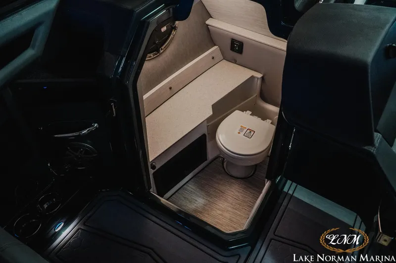 Slide: The Image of 2026 Cobalt R6 Surf boat interior with compact bathroom, featuring a modern toilet and sleek design. - 14