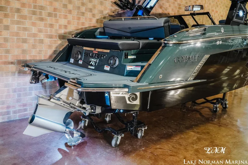 Slide: The Image of 2026 Cobalt R6 Surf boat displayed indoors at Lake Norman Marina. - 23