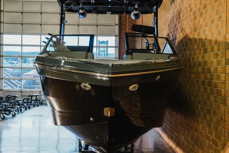 Slide: The Image of 2026 Cobalt R6 Surf boat in a showroom, front view, brick wall background. - 4