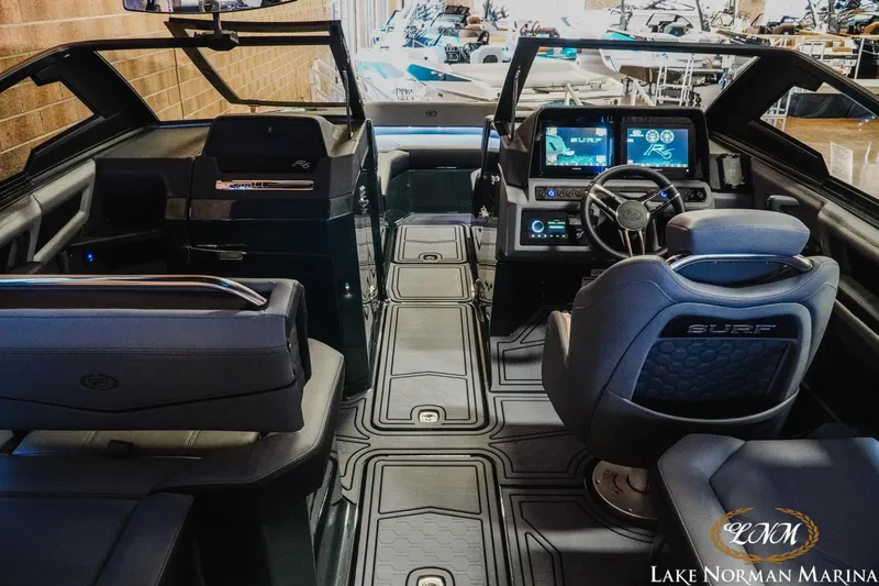 Slide: The Image of 2026 Cobalt R6 Surf boat interior with advanced dashboard and seating at Lake Norman Marina. - 8