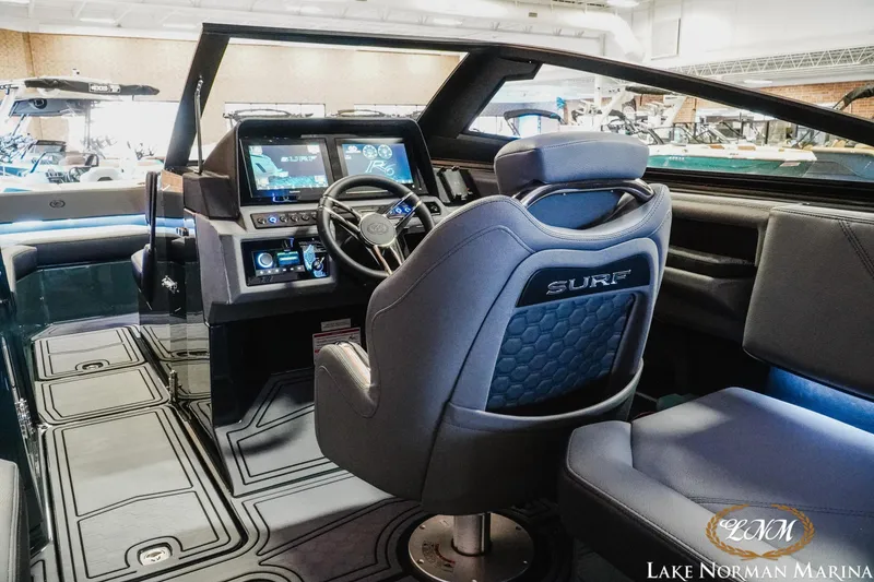 Slide: The Image of 2026 Cobalt R6 Surf boat interior with advanced dashboard and steering, showcased at Lake Norman Marina. - 9
