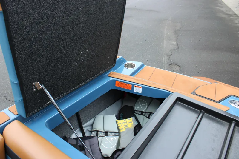 Slide: The Image of 2023 Axis A225 boat storage compartment with life jackets and safety gear. - 13