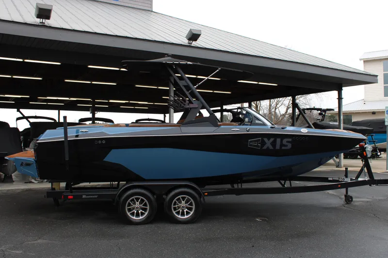 Slide: The Image of 2023 Axis A225 boat on trailer under covered area, side view. - 19