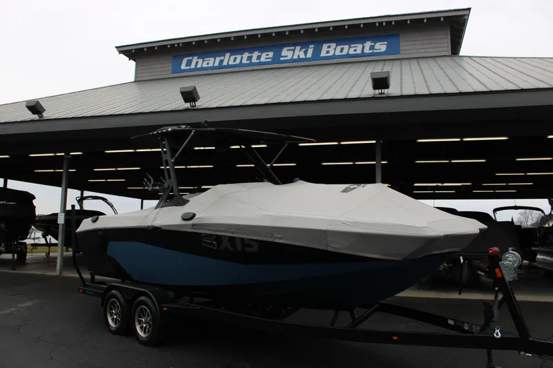Slide: The Image of 2023 Axis A225 boat at Charlotte Ski Boats dealership, covered and on trailer. - 23