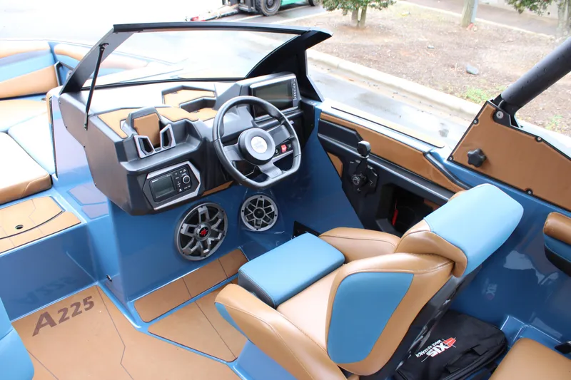 Slide: The Image of 2023 Axis A225 boat interior with modern dashboard and seating. - 4