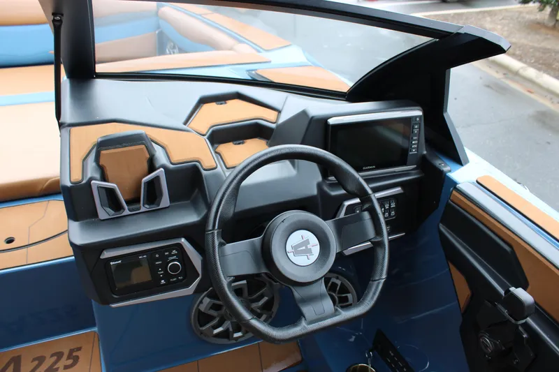 Slide: The Image of 2023 Axis A225 boat dashboard with steering wheel and digital display. - 5