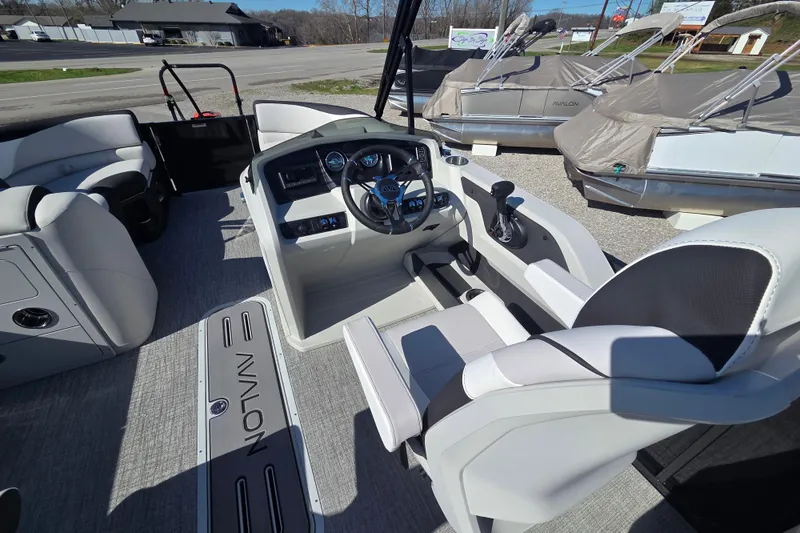 Slide: The Image of 2026 Avalon Platinum LSZ 2585 Quad Lounger Shift boat interior with modern helm and seating. - 9